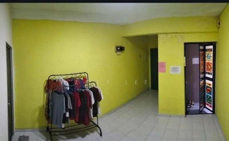 Room features: yellow painted walls, white tiled flooring, clothes rack with hanging clothes, doorway with glass panel door, light fixture on ceiling.