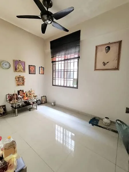 Living features: white painted walls, glossy ceramic tile flooring, 5-blade ceiling fan, large window with black blinds, decorative wall clock, framed artwork on wall, small altar with religious artifacts, decorative items on display table; style: minimalist.
