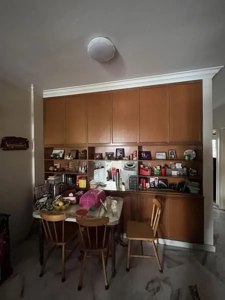 Room features: wooden cabinetry, cream walls, marble flooring, round ceiling light, dining table, wooden dining chairs, decorative items on shelves, photographs on display.