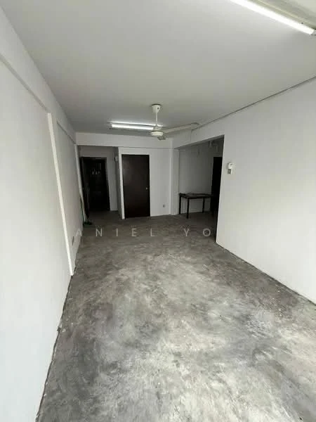 Room features: grey concrete flooring, white painted walls, exposed ceiling with fluorescent lights, ceiling fan, wooden door, open layout; style: minimalist.