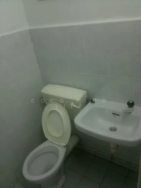 Bathroom features: white tiled walls, grey tiled flooring, one-piece toilet, white sink, chrome faucet, toilet paper holder, wall-mounted mirror.