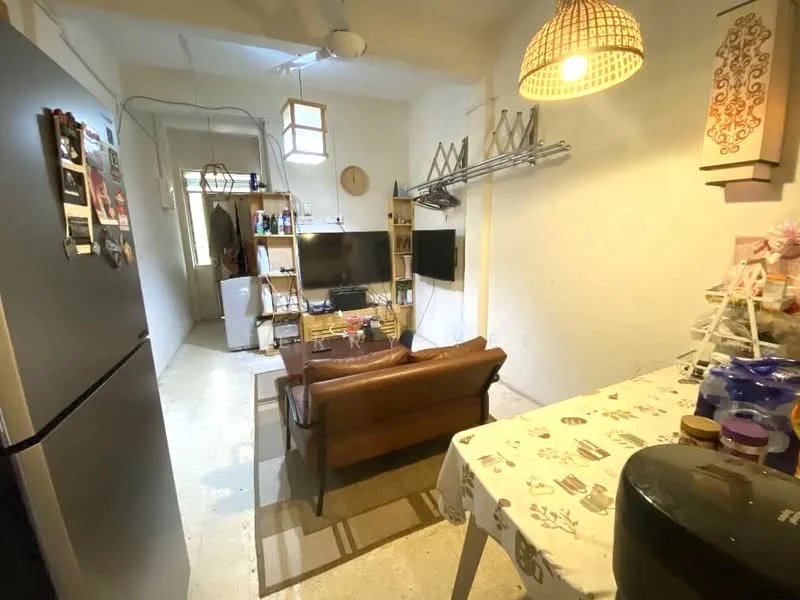 Living features: brown leather sofa, wooden coffee table, TV on wooden console, wall-mounted TV, refrigerator, kitchen table with patterned tablecloth, ceiling fan, hanging light fixture, open shelving, decorative wall art, neutral painted walls, concrete flooring; style: modern.