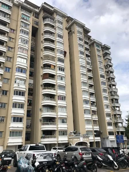Exterior type: mid-rise condominium; features: cream painted facade, balconies with decorative railings, multiple storeys, windows with white frames, parking area with cars, surrounding motorcycles, urban setting, cloudy sky; style: modern.
