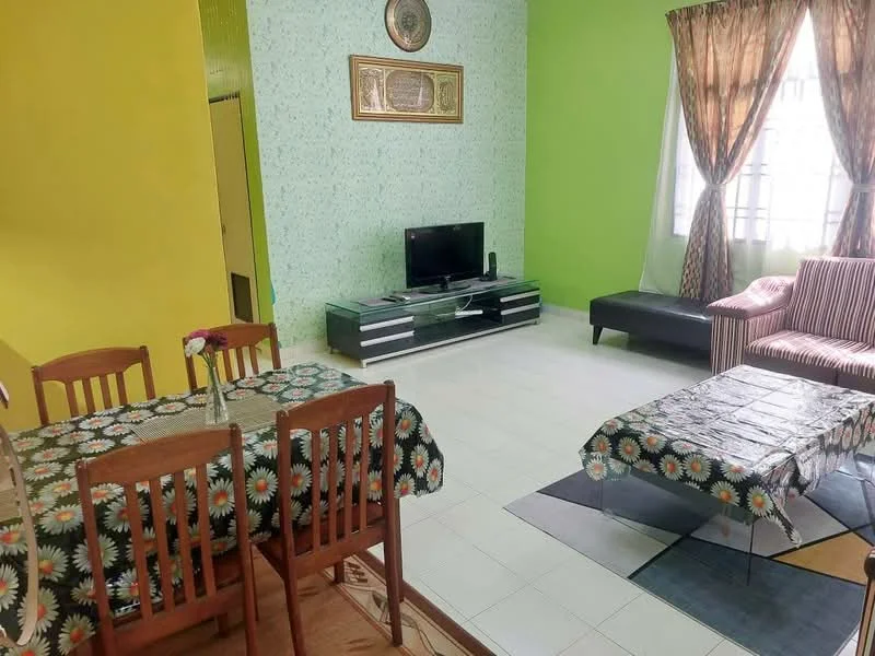 Living features: green painted walls, white tiled flooring, sofa in black, striped armchair, coffee table with patterned surface, TV console with storage, wall-mounted TV, curtains in brown and gold, decorative wall art, area rug with geometric pattern; style: modern. Dining features: wooden dining table, 4 wooden dining chairs, tablecloth with floral pattern, flower vase on table; style: modern.