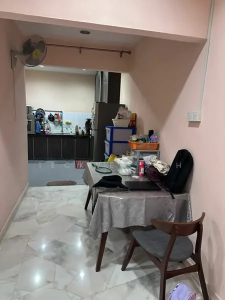 Room features: marble flooring, pink painted walls, ceiling fan, dining table with tablecloth, wooden chair, kitchen area visible in background, kitchen cabinets, countertop with appliances, plastic storage boxes, various kitchen utensils; style: modern.
