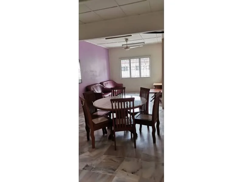 Living features: purple accent wall, white painted walls, marble flooring, ceiling fan, 3-seater leather sofa in burgundy, wooden dining table, 6 wooden dining chairs, window with metal grille, natural light from window; style: modern.