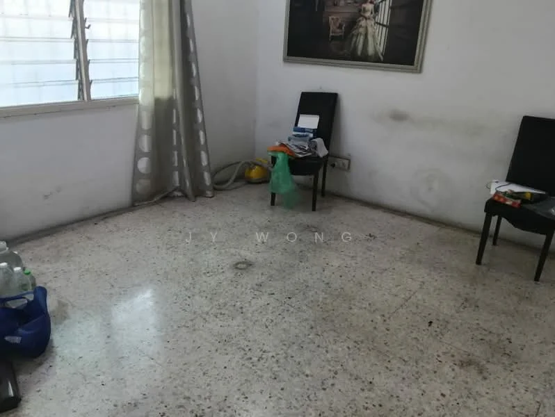 Room features: white painted walls, polished concrete flooring, large window with sheer curtains, two black chairs, various items on the floor, vacuum cleaner, plastic bags, bottled water.