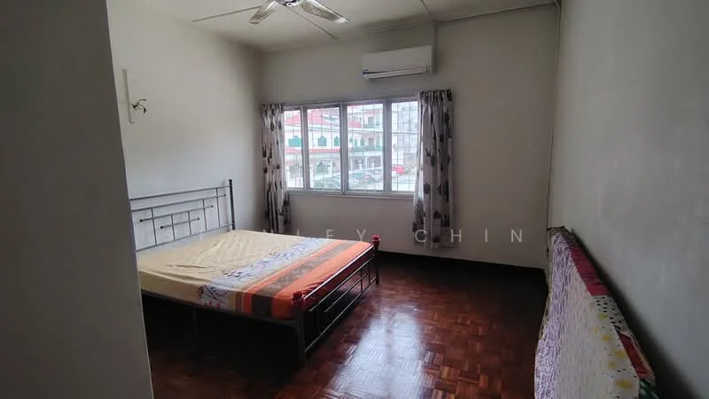 Bedroom features: wooden flooring, white painted walls, ceiling fan, window with sheer curtains, double bed with metal frame, bedside table, air conditioning unit, decorative throw on bed; view: city.