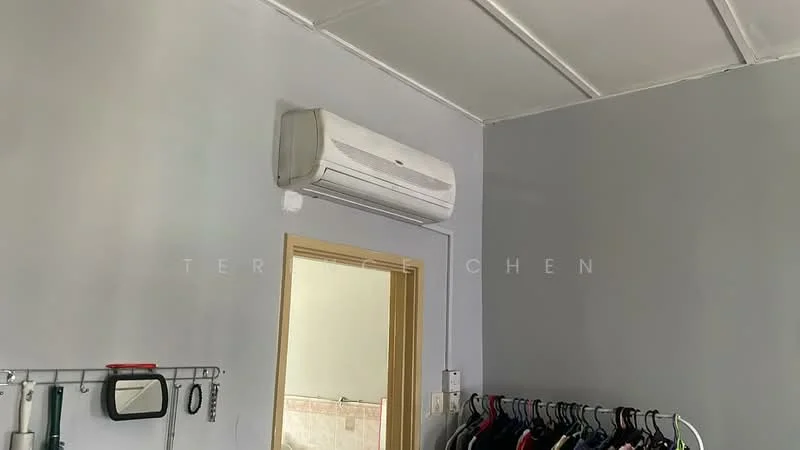 Room features: grey painted walls, wall-mounted split AC, door frame, clothing rack with hangers, light-colored ceiling, tile flooring.