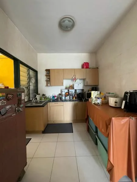 Kitchen features: wood cabinetry, stainless-steel sink, chrome faucet, built-in microwave, rice cooker, toaster, refrigerator, countertop with appliances, tile flooring, ceiling light fixture, window with grill, black countertop mat; style: modern.