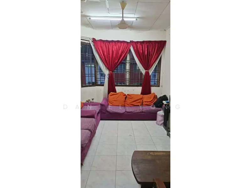 Living features: L-shape sectional sofa in purple, 2-seater sofa in pink, white tiled flooring, ceiling fan, red curtains, large windows, wooden coffee table, wall-mounted TV, painted walls with some wear.