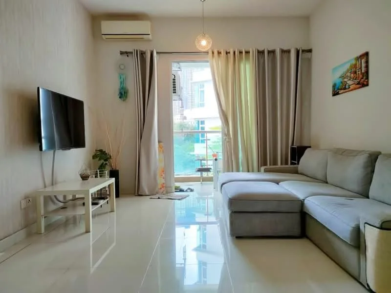 Living features: grey L-shape sectional sofa, white coffee table, wall-mounted TV, floor-to-ceiling windows, sheer curtains, recessed downlights, air conditioning unit, decorative wall art, potted plant, glossy tile flooring; style: modern; view: garden.