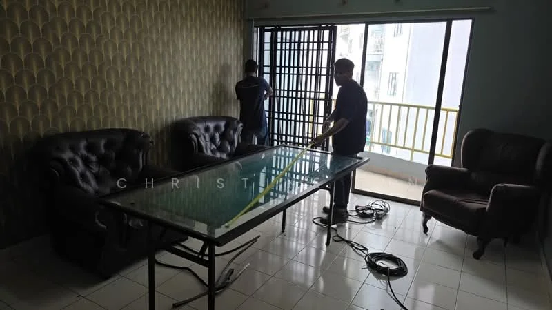 Living features: two 3-seater leather sofas in dark brown, glass coffee table with metal frame, white tiled flooring, green accent wall with patterned wallpaper, floor-to-ceiling windows, curtain rod with sheer curtains, balcony door, visible electrical cords on the floor; style: modern; view: city.