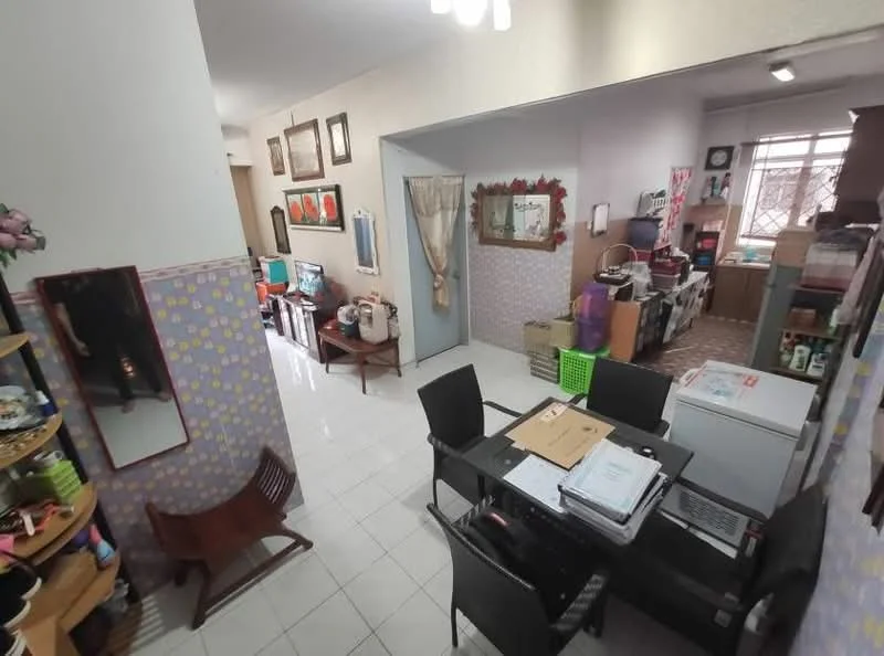 Room features: white painted walls, glossy white tile flooring, ceiling lights, dining table with chairs, refrigerator, wall-mounted TV, decorative wall frames, open shelving unit, storage boxes, green storage basket, wooden chair, carpeted area, window with curtains; style: modern.
