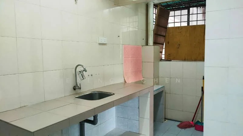 Kitchen features: single-bowl stainless-steel sink, chrome pull-down faucet, white tiled walls, grey tiled countertop, grey tiled flooring, window with wooden shutters, mop and broom visible, open space layout.