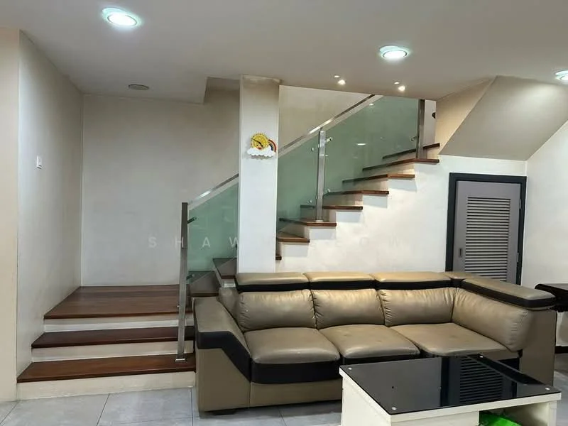 Living features: L-shape sectional sofa in beige and black, glass coffee table, wooden staircase with glass railing, white painted walls, recessed downlights, tile flooring, decorative wall art, built-in storage cabinet; style: modern.