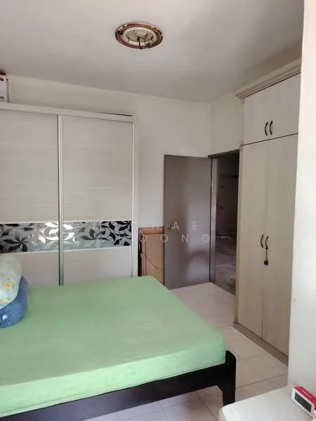 Bedroom features: green mattress on bed frame, built-in wardrobe with sliding doors, cream painted walls, tile flooring, ceiling light fixture, doorway leading to another room, small bedside table, window with no visible treatment.