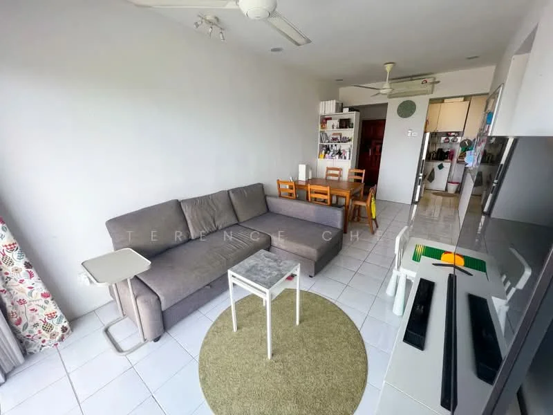Living features: grey fabric L-shape sectional sofa, white coffee table, round area rug in green, wall-mounted TV, TV console, ceiling fan, white tiled flooring, floor-to-ceiling windows with sheer curtains, decorative curtains with floral pattern, dining table with wooden chairs, open layout to kitchen; style: modern. Kitchen features: open kitchen layout, white cabinetry, stainless-steel appliances, countertop with bar seating, refrigerator, built-in oven, microwave, sink, tile backsplash; style: modern.