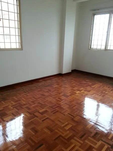 Room features: wooden flooring, white painted walls, two windows with grid pattern, natural light, corner room.