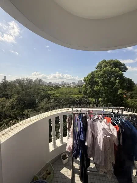 Balcony features: balustrade with white columns, tiled flooring, clothes drying rack with clothes, view of city skyline, view of greenery, overhead covering, outdoor space; view: city.