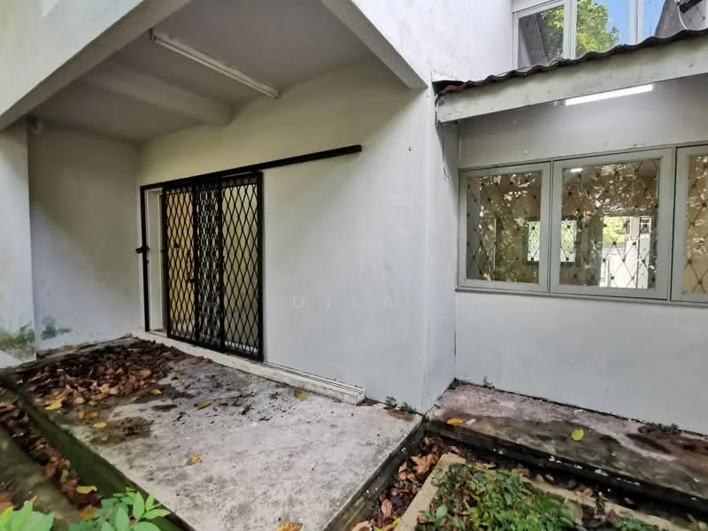 Exterior features: white painted facade, metal security grille door, large windows with metal grilles, concrete flooring, surrounding foliage, leaves on the ground.