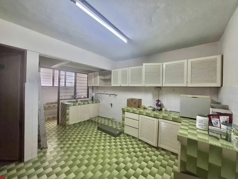 Kitchen features: green patterned floor tiles, white cabinetry with louvered doors, double-bowl stainless-steel sink, chrome faucet, built-in countertop with storage, wall-mounted shelves, window with metal grille, fluorescent ceiling light.