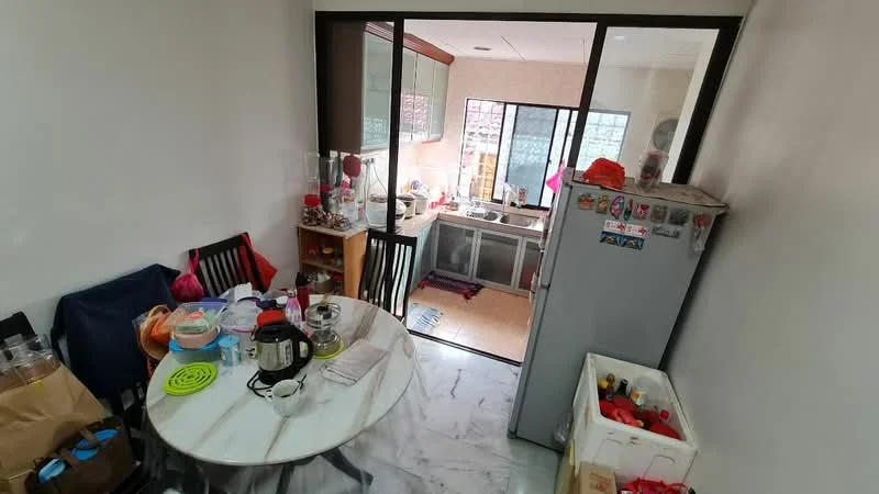 Kitchen features: marble flooring, white painted walls, glass sliding door, kitchen cabinets with glass fronts, stainless-steel fridge, round dining table, black dining chairs, various kitchen appliances, sink, countertop, window with natural light, decorative items on the table.
