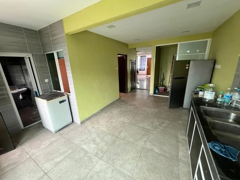 Kitchen features: grey ceramic tile flooring, green painted walls, stainless-steel sink, single-bowl stainless-steel sink, built-in cabinets, black fridge, washing machine, countertop, open layout, doorway to bathroom, doorway to hallway; style: modern. Room features: grey ceramic tile flooring, green painted walls, doorway to kitchen, doorway to living area.