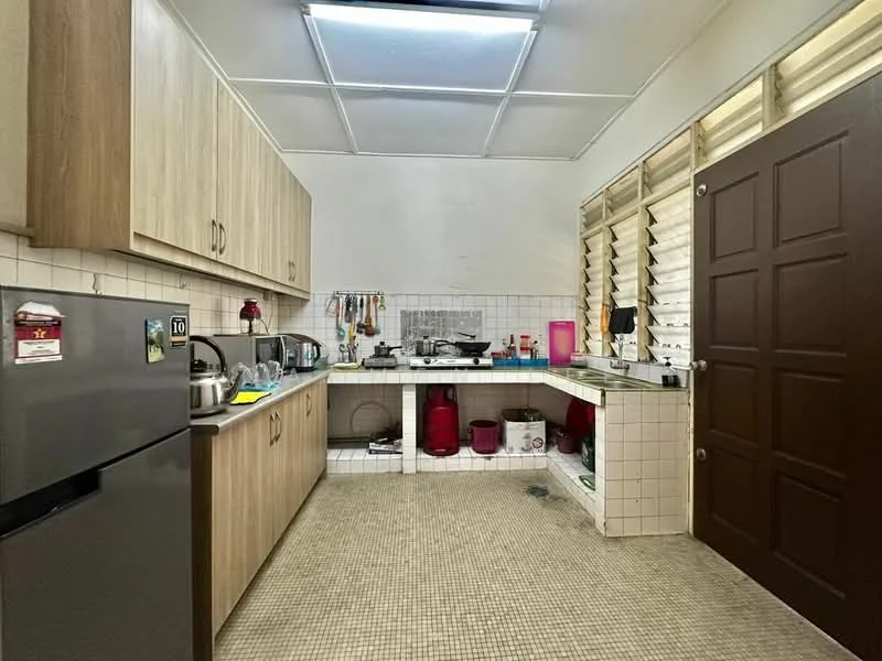 Kitchen features: laminate cabinetry in light wood finish, white tiled backsplash, single-bowl stainless-steel sink, chrome pull-down faucet, built-in gas stove, exhaust hood, refrigerator in stainless steel, countertop with tiled surface, floor tiles in beige, window with louvered shutters, wall-mounted storage racks, kitchen appliances including kettle and toaster; style: modern.