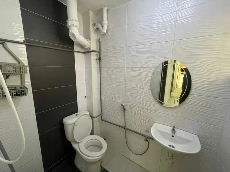 Bathroom features: white ceramic toilet, round mirror, wall-mounted sink, chrome faucet, shower head with handheld attachment, white textured wall tiles, dark grey accent wall tiles, grey floor tiles, exposed plumbing, wall-mounted storage rack; style: modern.