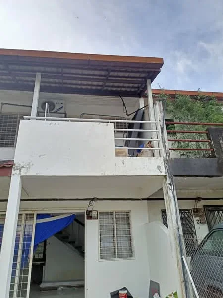Exterior type: linked terrace house; features: white painted facade, flat roof with overhang, balcony with railing, exposed concrete, staircase leading to upper level, metal grilles on windows, blue tarpaulin covering, greenery visible on upper level; style: modern.