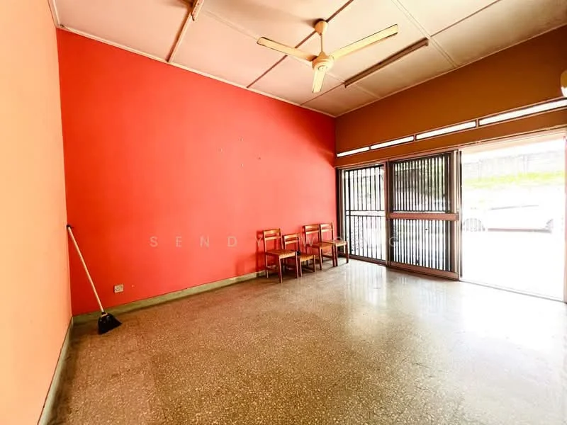 Living features: orange painted walls, grey terrazzo flooring, ceiling fan, sliding glass door, floor-to-ceiling windows, wooden chairs, sweeping broom, natural light from windows.