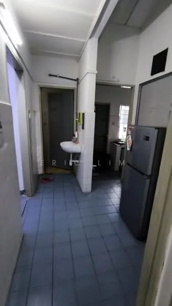 Room features: blue ceramic tile flooring, white painted walls, single-bowl sink, wall-mounted mirror, stainless-steel fridge, doorway leading to another room, window with natural light, light fixture on ceiling.
