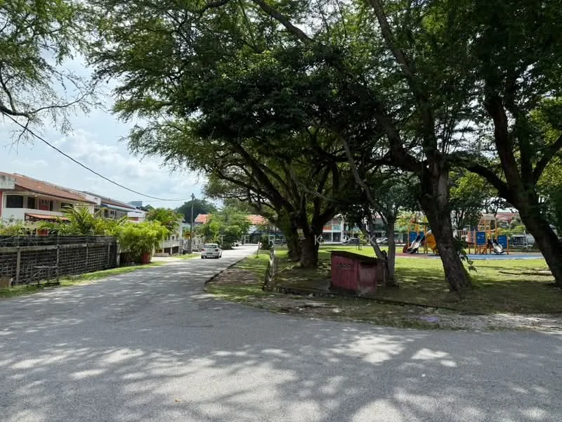 Exterior features: manicured lawn, mature trees, paved road, playground equipment visible, residential buildings in background, street lighting, curbside parking.