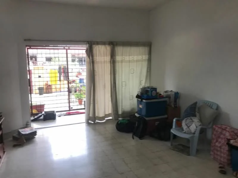 Room features: white painted walls, tiled flooring, sliding glass door, curtains, plastic chair, backpacks, storage boxes, decorative cushions.