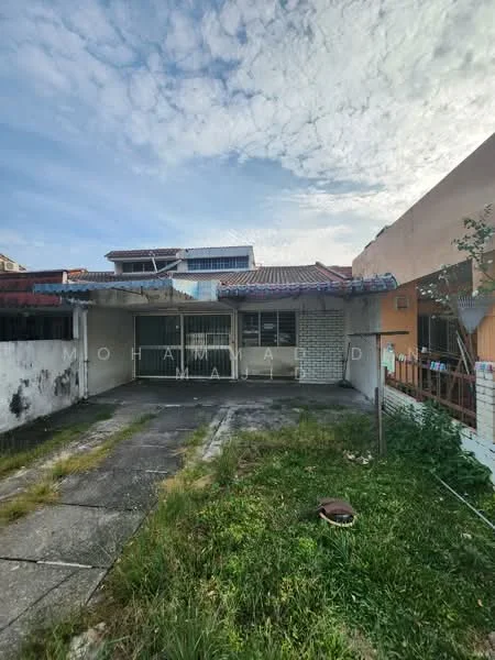 Exterior type: detached bungalow; features: single-storey structure, exposed brick wall, roof with tiles, concrete driveway, overgrown grass, patio area, windows with metal grilles, front yard, faded paint, partially covered porch; style: traditional.