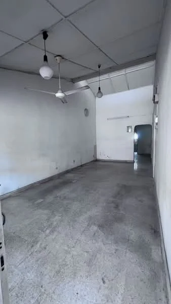 Room features: grey concrete flooring, white painted walls, exposed ceiling with beams, 3 pendant lights, 2 ceiling fans, one wall-mounted light fixture, doorway leading to another room; style: minimalist.