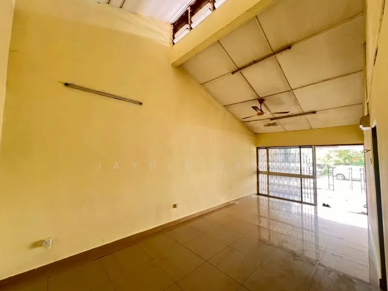 Room features: yellow painted walls, high ceiling with exposed beams, floor-to-ceiling windows, sliding glass door, ceramic tile flooring, ceiling fan, natural light from windows, open layout.