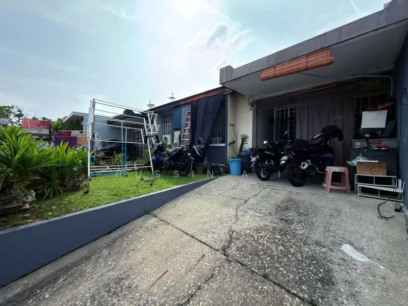 Exterior type: linked terrace house; features: concrete driveway, manicured lawn, garden area with plants, covered porch, metal gate, two parked motorcycles, ladder leaning against the wall, clothes drying rack, exterior wall with blue paint, window with security bars; style: modern.