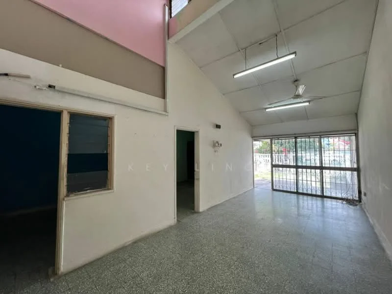 Room features: high ceiling, white painted walls, grey tiled flooring, large glass sliding door, multiple fluorescent ceiling lights, open layout, windows with metal grilles, corner windows, natural light from outside, exposed ceiling beams; style: modern; view: garden.