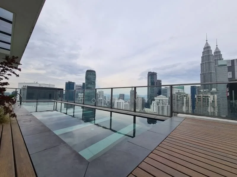 Exterior type: high-rise condominium; features: infinity pool, pool deck with wooden flooring, glass railing, city skyline view, surrounded by high-rise buildings, landscaping with plants; style: modern.