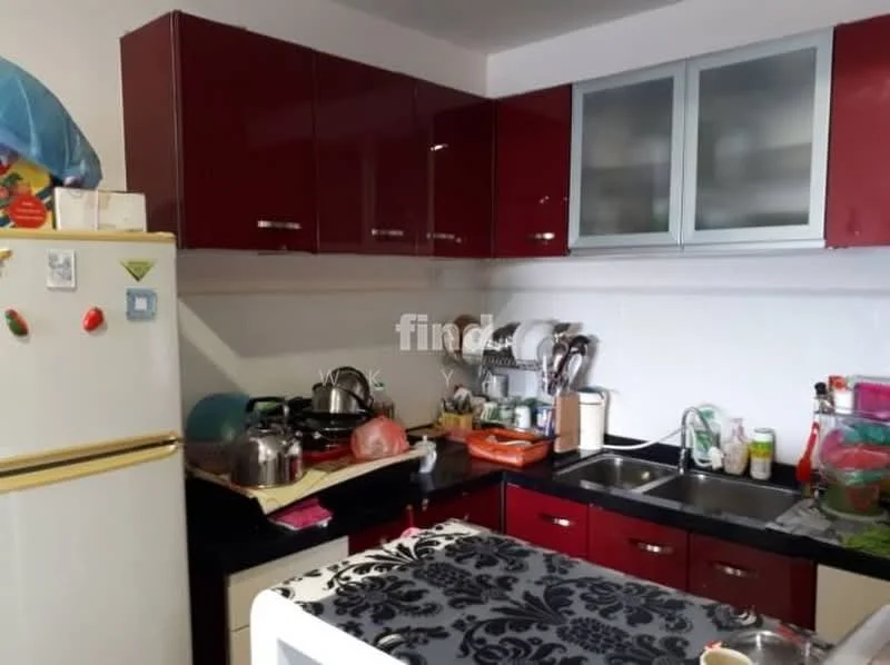 Kitchen features: red cabinetry, black countertop, stainless-steel sink, chrome faucet, white fridge, kitchen utensils on countertop, multiple pots and pans, glass-front upper cabinets, tile backsplash, decorative tablecloth; style: modern.