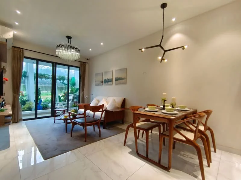 Living features: marble tile flooring, white painted walls, recessed downlights, chandelier, 5-blade ceiling fan, large sliding glass door, sheer curtains, wooden dining table, 4 dining chairs, wooden sofa, decorative wall art, area rug, indoor plants; style: modern; view: garden.
