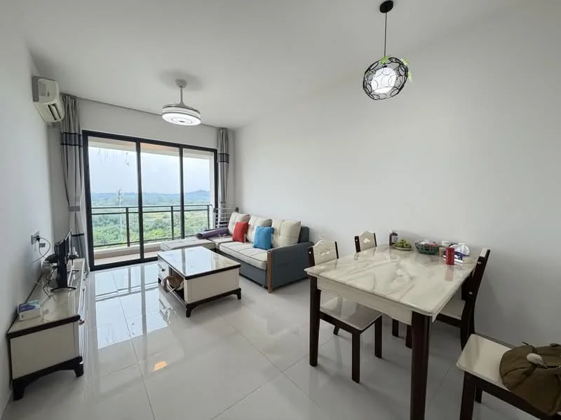 Living features: white painted walls, glossy tile flooring, 5-blade ceiling fan with light, floor-to-ceiling windows, sliding glass door, sofa with cushions in blue and beige, coffee table, dining table with 4 chairs, TV console, decorative pendant light; style: modern; view: mountain.