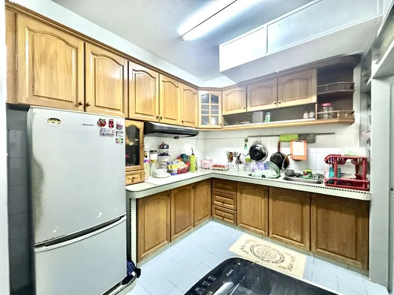 Kitchen features: wood cabinetry with golden finish, white countertop, stainless-steel fridge, built-in oven, ceramic tile flooring, single-bowl stainless-steel sink, chrome pull-down faucet, wall-mounted cabinets, kitchen appliances visible, decorative rug, window for natural light, light fixture on ceiling; style: traditional.