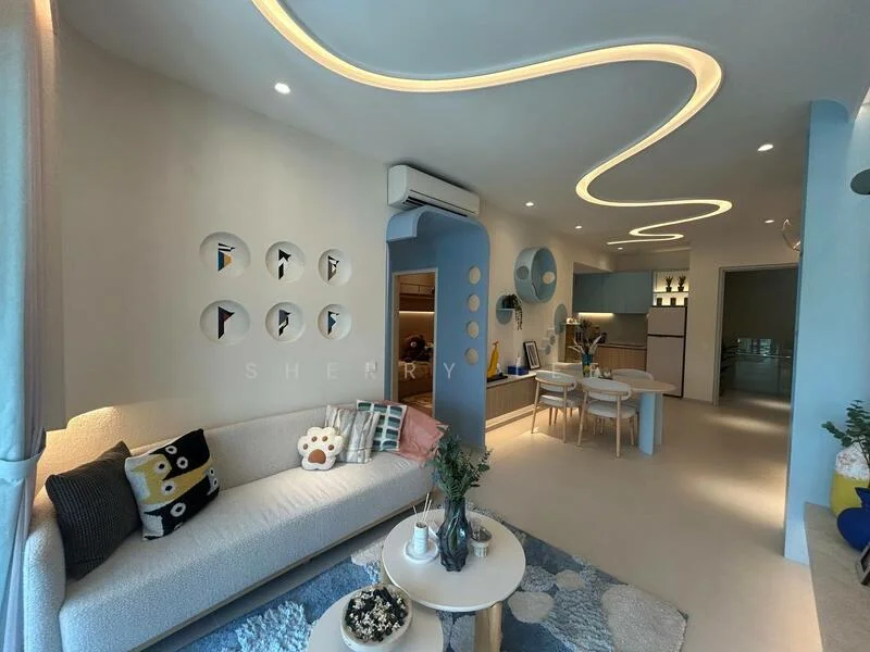 Living features: curved ceiling with integrated LED lighting, light blue accent wall, cream painted walls, sofa with light fabric upholstery, decorative cushions with various patterns, round coffee table, area rug with abstract pattern, wall-mounted air conditioning unit, dining table with white chairs, open shelving with decorative items, kitchen area visible in background; style: modern.