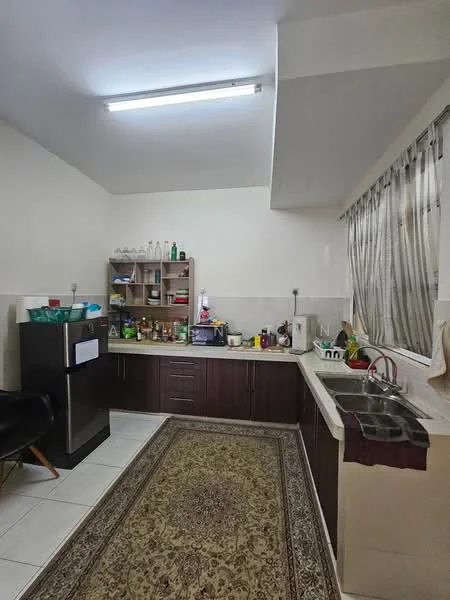Kitchen features: dark wood cabinetry, white countertop, double-bowl stainless-steel sink, chrome pull-down faucet, black refrigerator, tile flooring, window with sheer curtains, kitchen rug with intricate pattern, various kitchen appliances and utensils on shelves; style: modern.