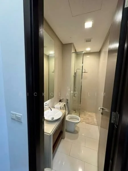 Bathroom features: single-sink vanity with white cabinet, chrome basin mixer, framed mirror, one-piece toilet, walk-in shower with glass enclosure, tile flooring, light-colored wall tiles, recessed downlights; style: modern.