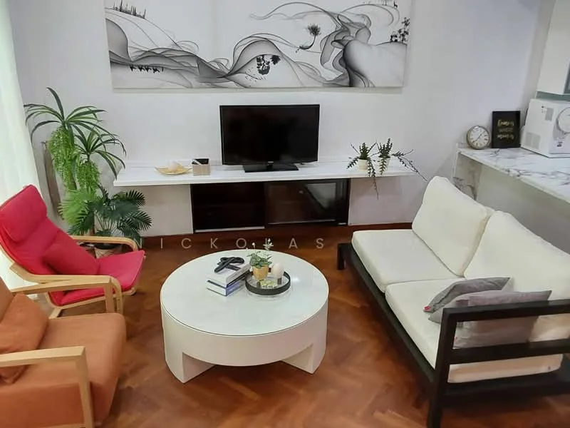 Living features: light wood parquet flooring, white walls, large wall-mounted TV, white console table, round white coffee table, 2-seater white sofa, red armchair, brown armchair, decorative plants, framed artwork on wall, clock on wall; style: modern.