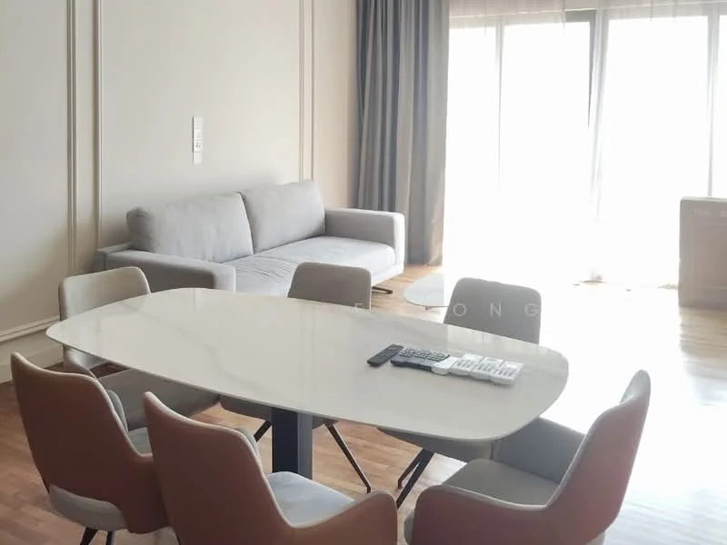 Dining features: oval dining table with white marble top, 6 upholstered dining chairs in beige and grey, floor-to-ceiling windows with sheer curtains, light wood flooring, grey fabric sofa, decorative wall paneling, recessed downlights, remote control on table; style: modern.